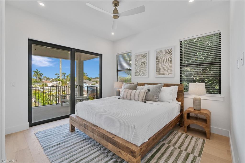 803 96th Avenue North Naples, FL 34108 - Photo 35 of 50 a bedroom with a large bed and a large window