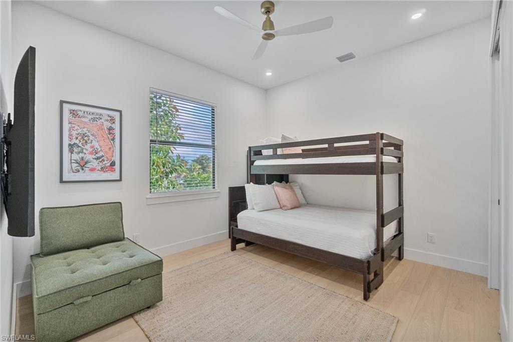 803 96th Avenue North Naples, FL 34108 - Photo 36 of 50 a bedroom with furniture and a ceiling fan