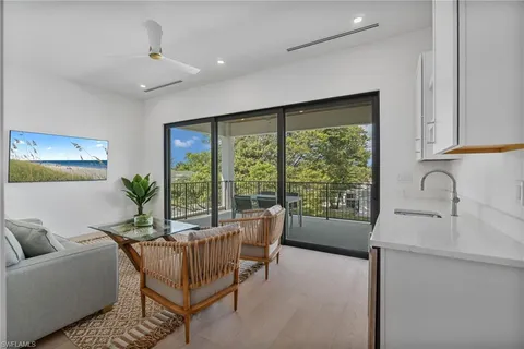 a view of a balcony with furniture and floor to ceiling window