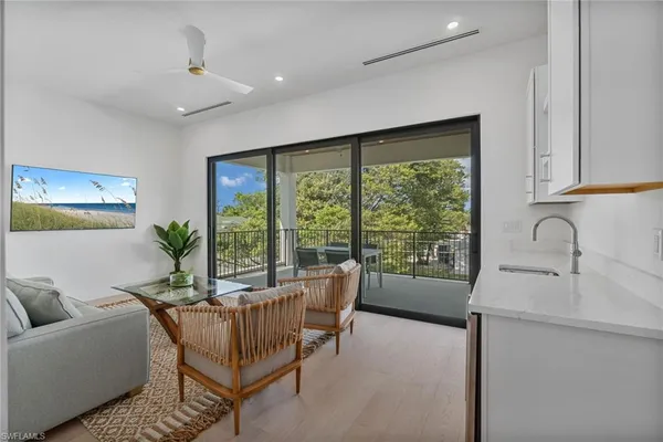 a view of a balcony with furniture and floor to ceiling window