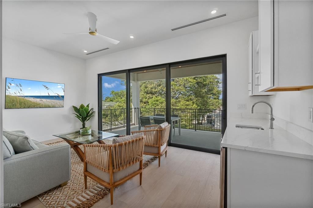 803 96th Avenue North Naples, FL 34108 - Photo 39 of 50 a living room with furniture and a large window