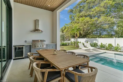 a kitchen with a table chairs and a refrigerator