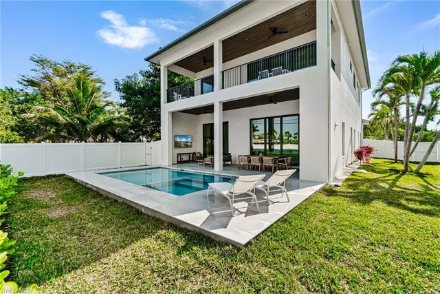 a view of swimming pool with outdoor seating and a ocean view