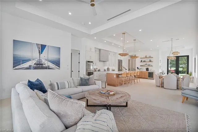 a living room with furniture and a chandelier