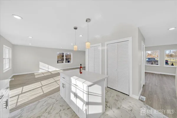 a spacious bathroom with a granite countertop sink and a mirror