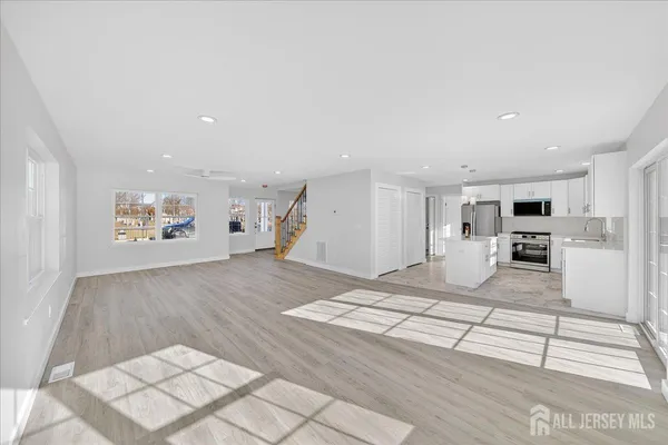 a view of kitchen with furniture and refrigerator