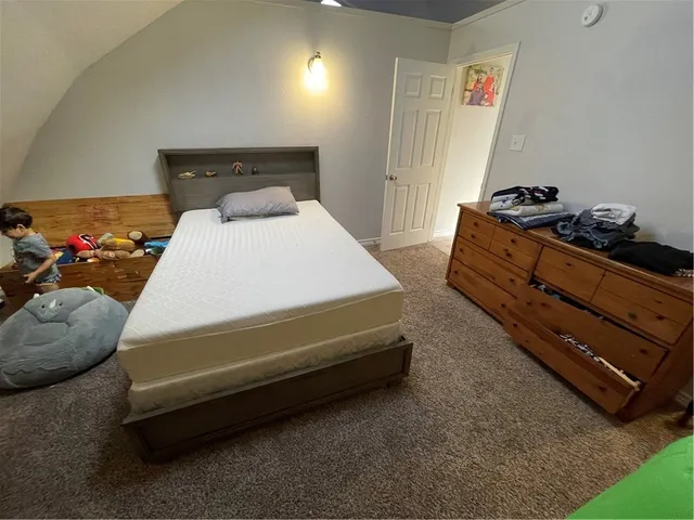 a spacious bedroom with a bed and a couch