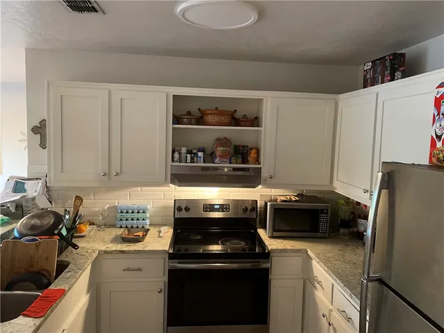 a kitchen with a stove and a refrigerator