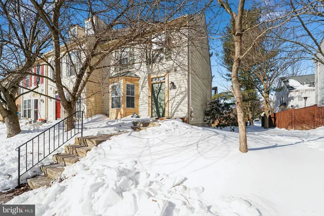 a view of a house with snow on the road
