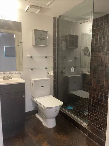 a bathroom with a toilet and a shower