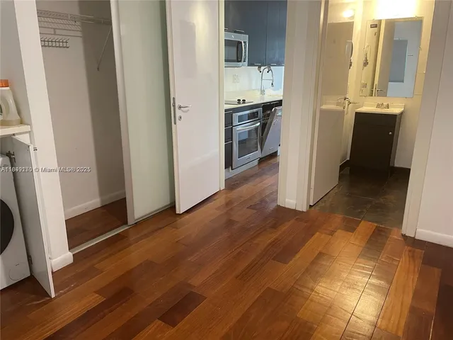 a view of a kitchen from the hallway