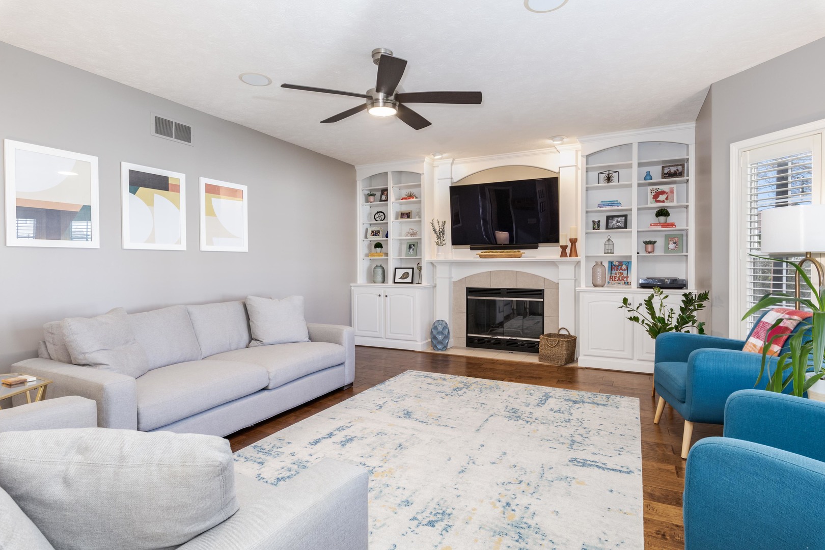 1223 Joy Walk Way Normal, IL 61761 - Photo 12 of 48 a living room with furniture a flat screen tv and a fireplace