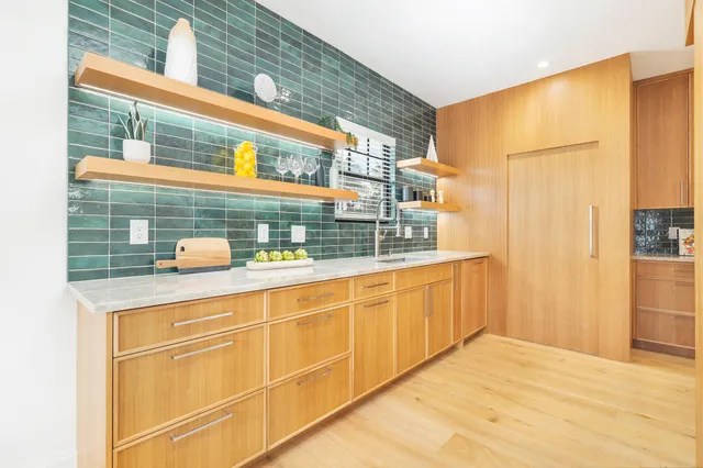 a view of a kitchen with a sink and a window