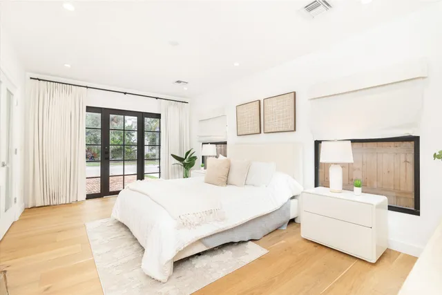 a bedroom with a large bed and a large window