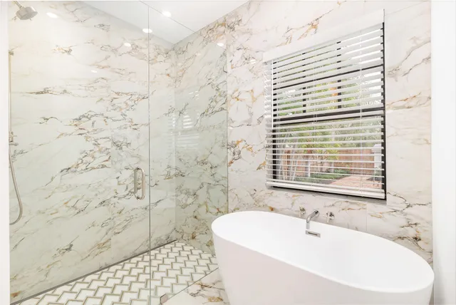 a bathroom with a bathtub and shower