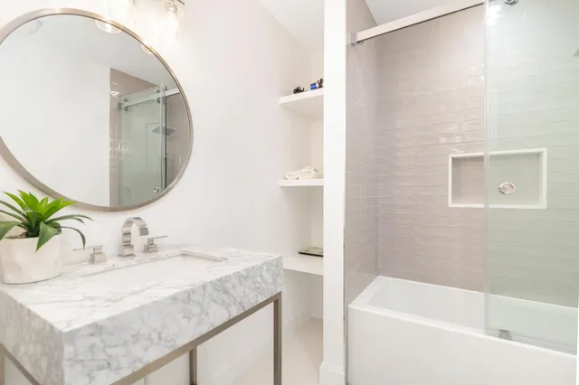 a bathroom with a granite countertop sink and a mirror