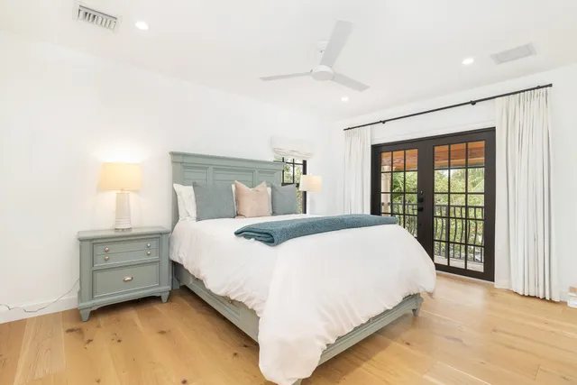 a bedroom with a large bed and a window