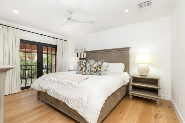a large bed sitting in a bedroom next to a window