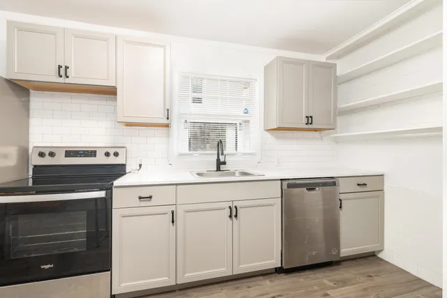 a kitchen with white cabinets and white appliances
