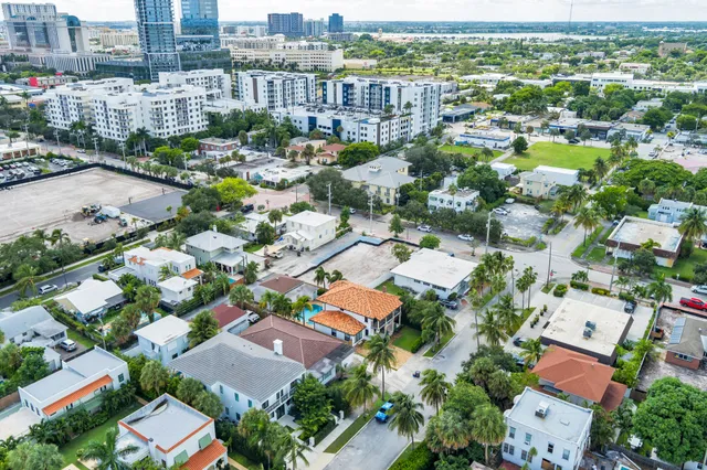 an aerial view of residential houses with city view