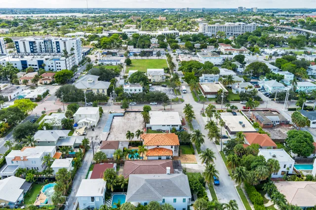 an aerial view of residential houses with city view