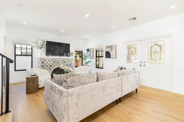 a living room with furniture a fireplace and a flat screen tv