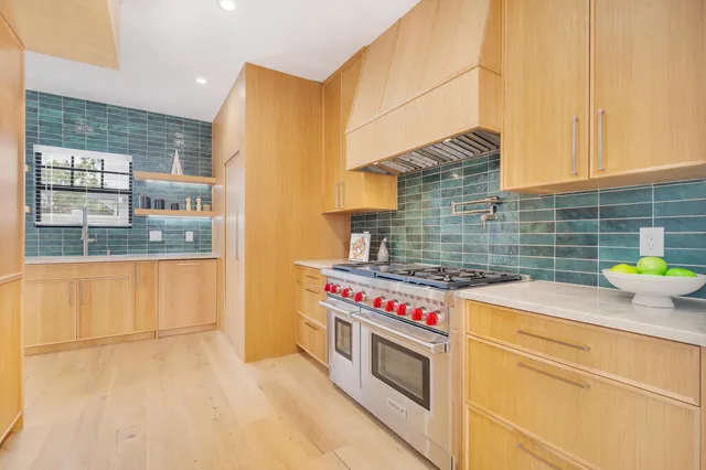 a kitchen with a stove and a white cabinets