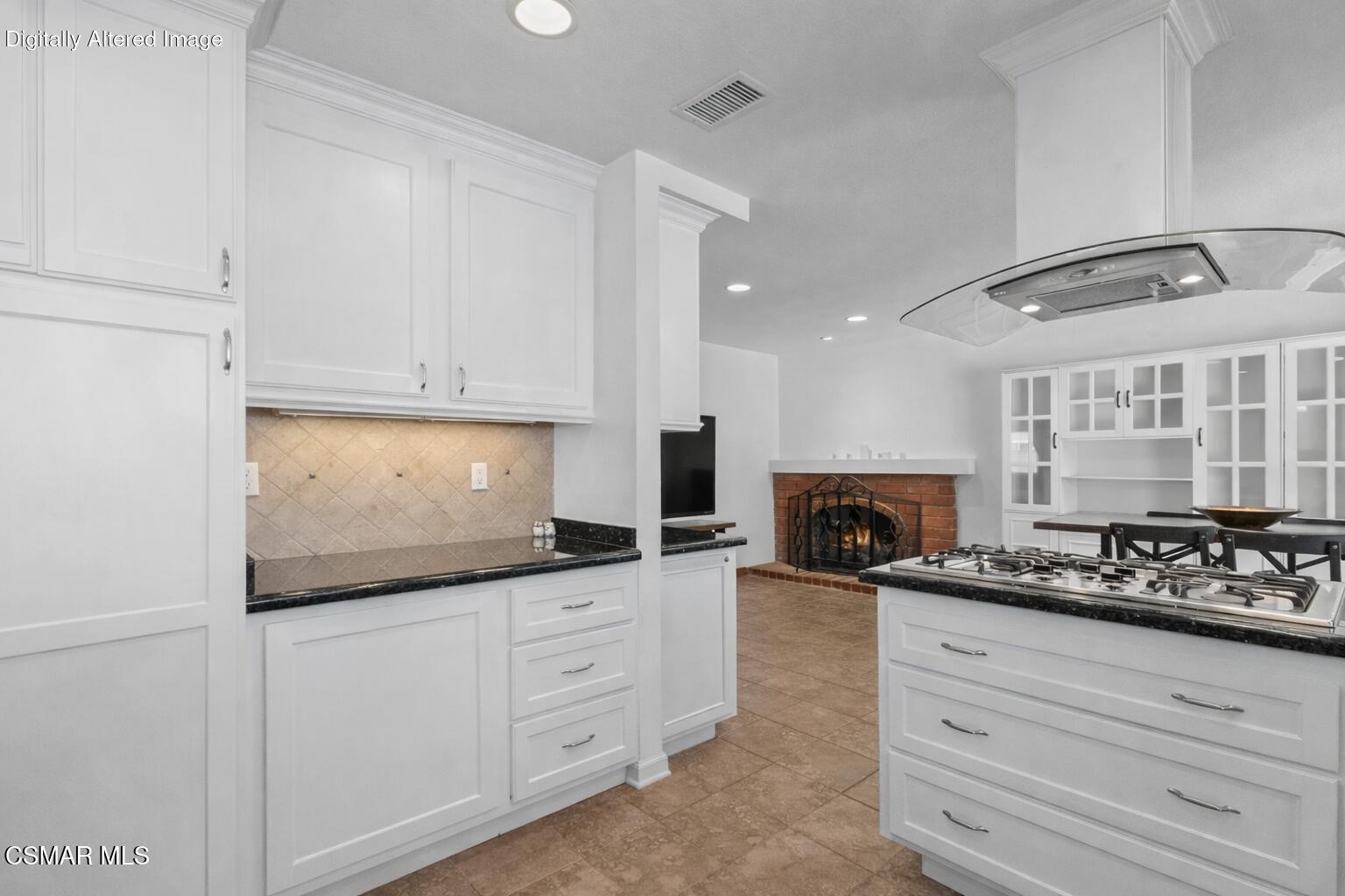 6435 Hazel Circle Simi Valley, CA 93063 - Photo 17 of 55 a kitchen with granite countertop a stove a sink and a white cabinets