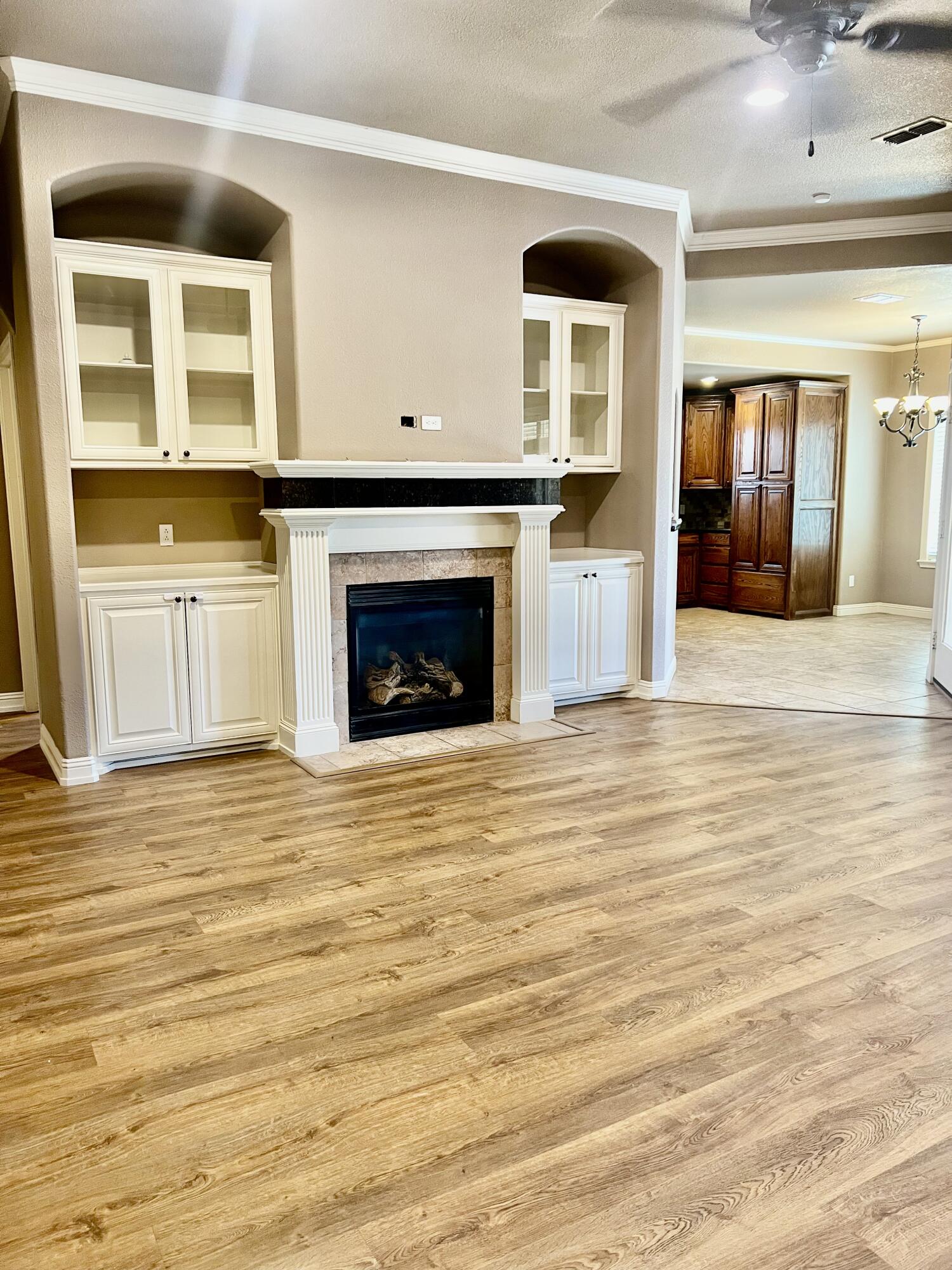 5513 104th Street Lubbock, TX 79424 - Photo 2 of 10 a view of an empty room with a fireplace and a window