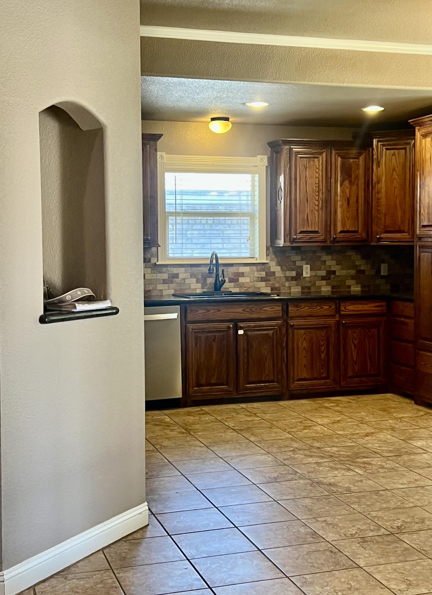 5513 104th Street Lubbock, TX 79424 - Photo 4 of 10 a view of kitchen with granite countertop sink and cabinets
