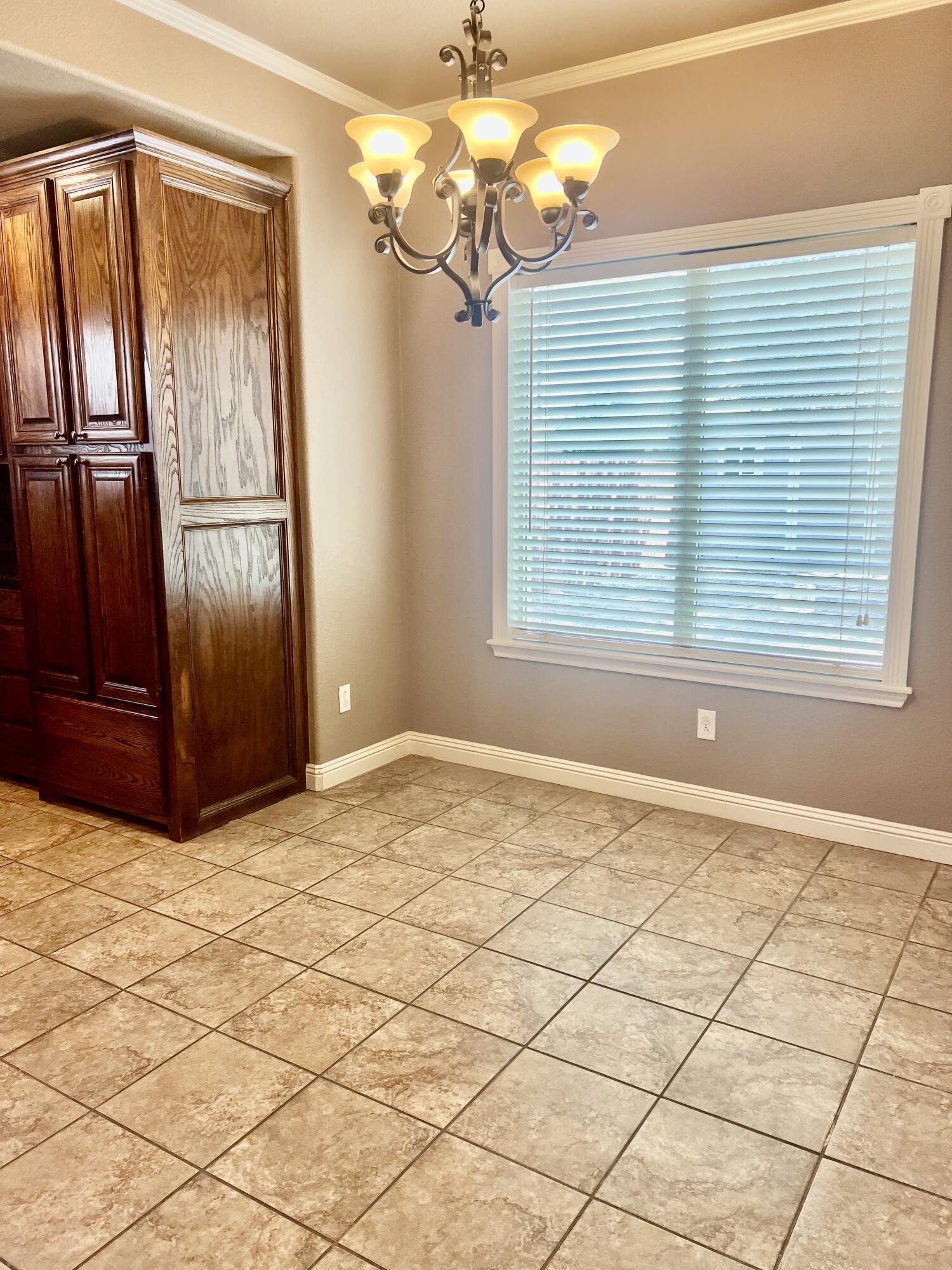 5513 104th Street Lubbock, TX 79424 - Photo 7 of 10 a view of an empty room with a window