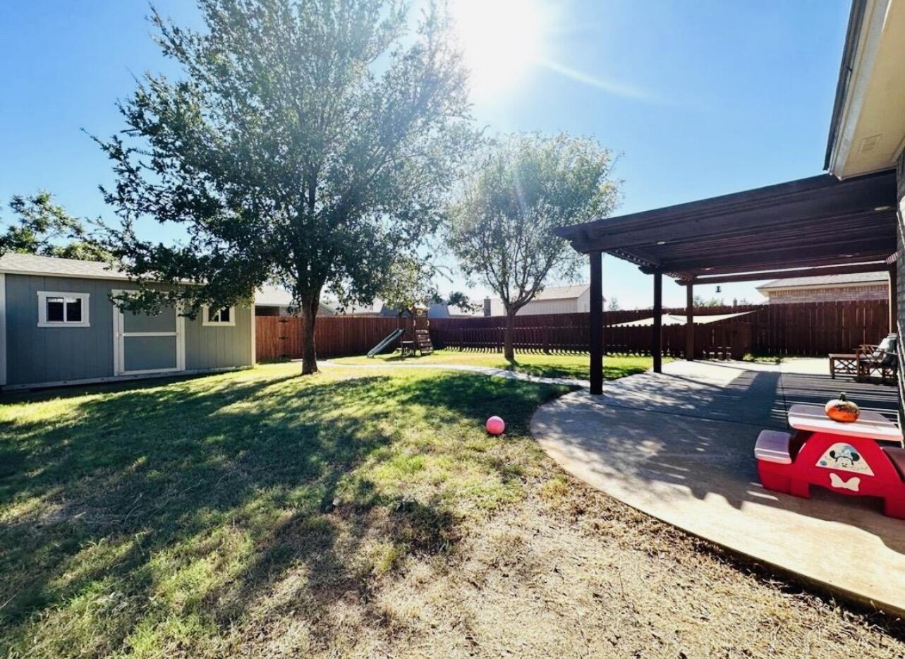 5513 104th Street Lubbock, TX 79424 - Photo 9 of 10 a view of a backyard with sitting area