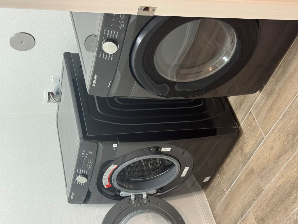 113 Caterpillar Lane Georgetown, TX 78628 - Photo 29 of 37 Laundry room featuring independent washer and dryer, wood tiled floors, and baseboards