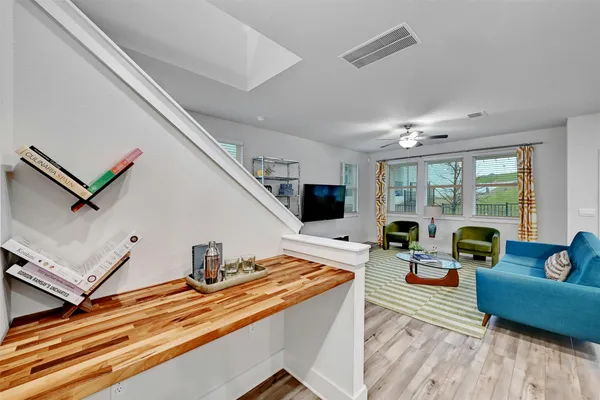 a living room with furniture and floor to ceiling window