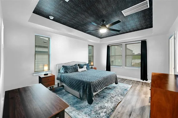 a room with a bed window and a flat screen tv