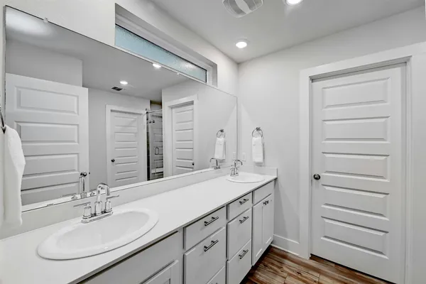 a bathroom with a double vanity sink and a mirror