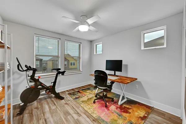 a work room with furniture and wooden floor
