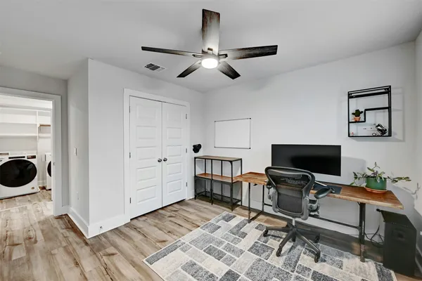 a view of a workspace with furniture and a window