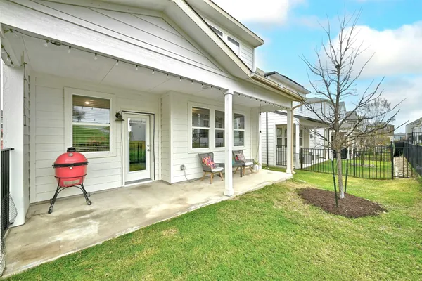 a view of a house with backyard and a fire pit
