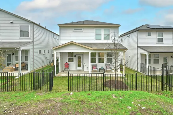 a front view of a house with a garden and plants