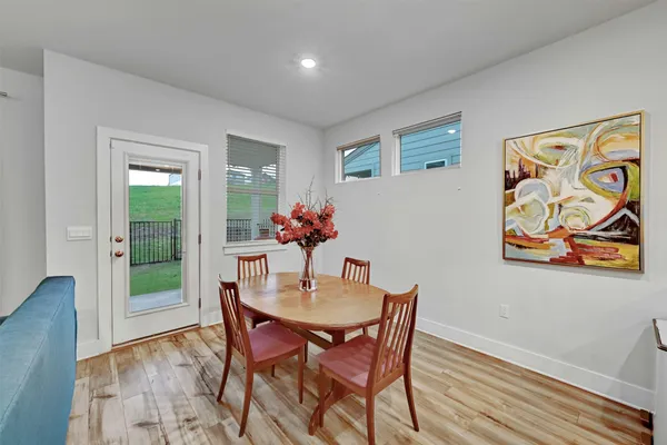 a view of a dining room with furniture and wooden floor