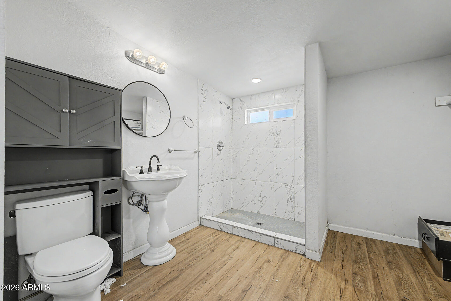 1030 North 28th Street Phoenix, AZ 85008 - Photo 14 of 24 a bathroom with a toilet a sink and a mirror