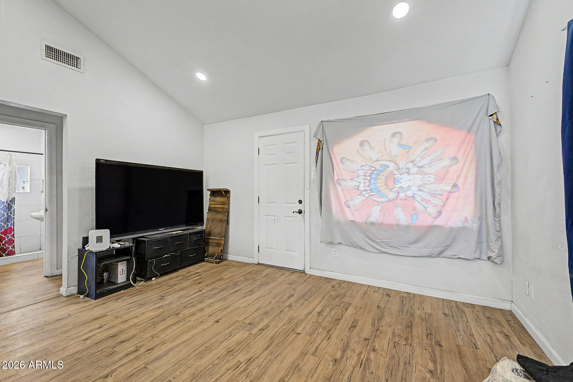 1030 North 28th Street Phoenix, AZ 85008 - Photo 4 of 24 a view of a livingroom with wooden floor and a flat screen tv