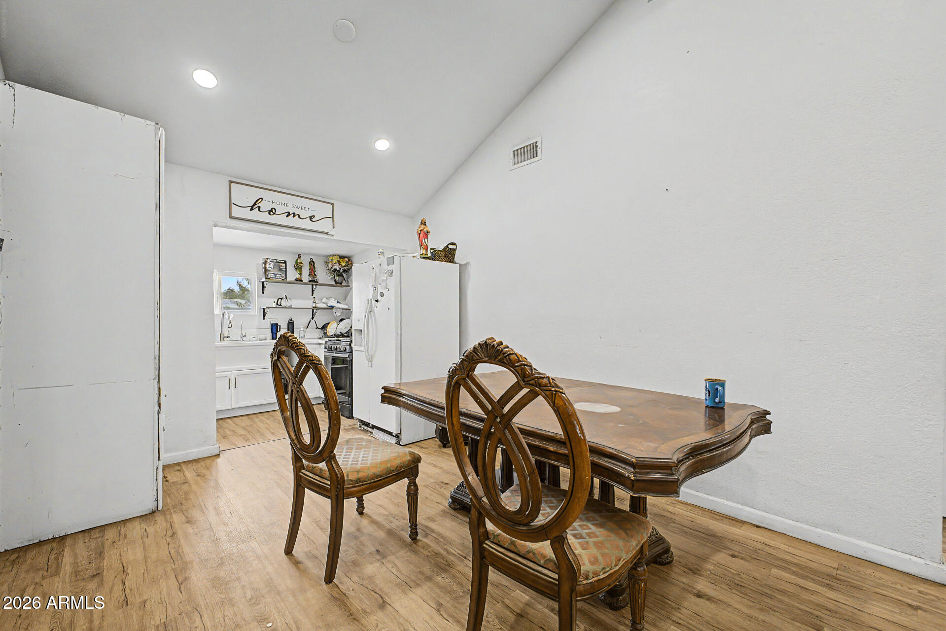 1030 North 28th Street Phoenix, AZ 85008 - Photo 7 of 24 a view of a dining room with furniture and a wooden floor