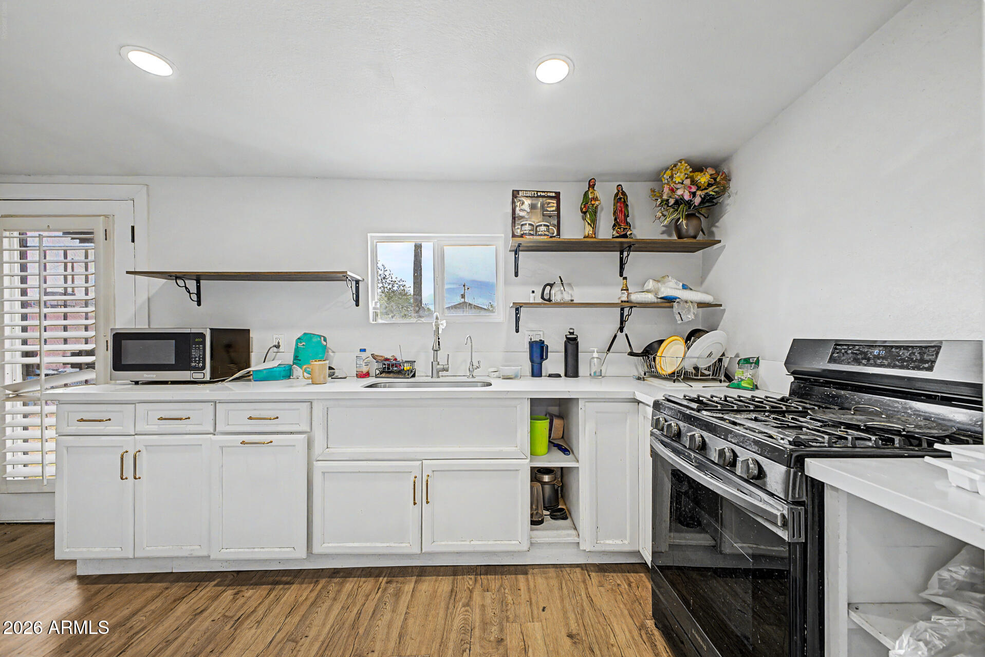 1030 North 28th Street Phoenix, AZ 85008 - Photo 9 of 24 a kitchen with white cabinets and appliances