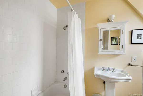 a bathroom with a sink a mirror and a bathtub