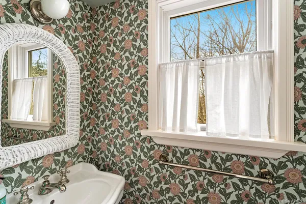 a bathroom with a sink a toilet and a window