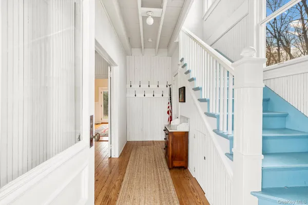 a view of entryway and hall with wooden floor