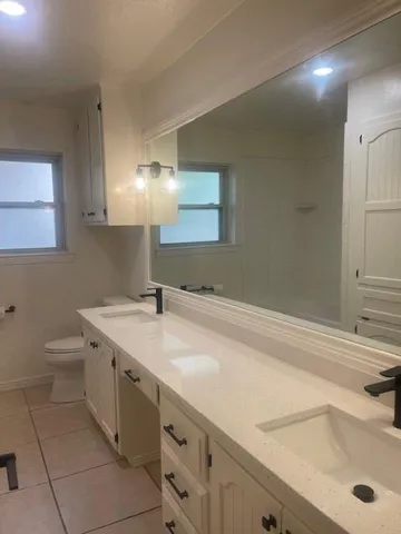 a spacious bathroom with a sink and a toilet