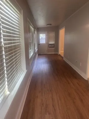 a view of wooden floor and windows in an empty room